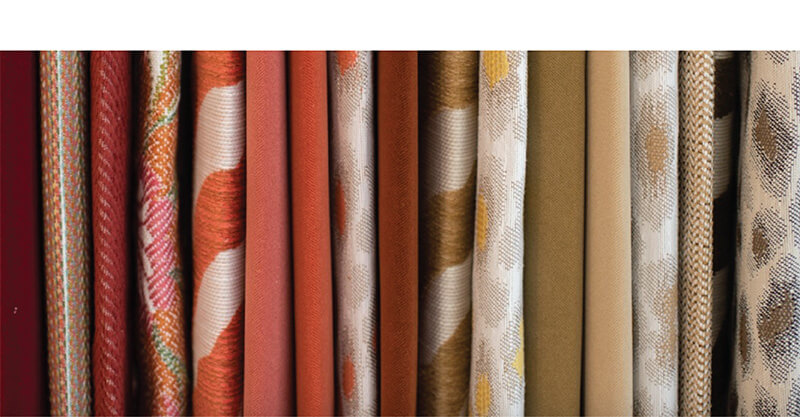 fabric samples in reds, oranges, yellows and creams